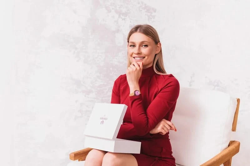 A women with red dress and jowissa swiss watch on her hand - the watch is swiss made with gold strap and purple dial
