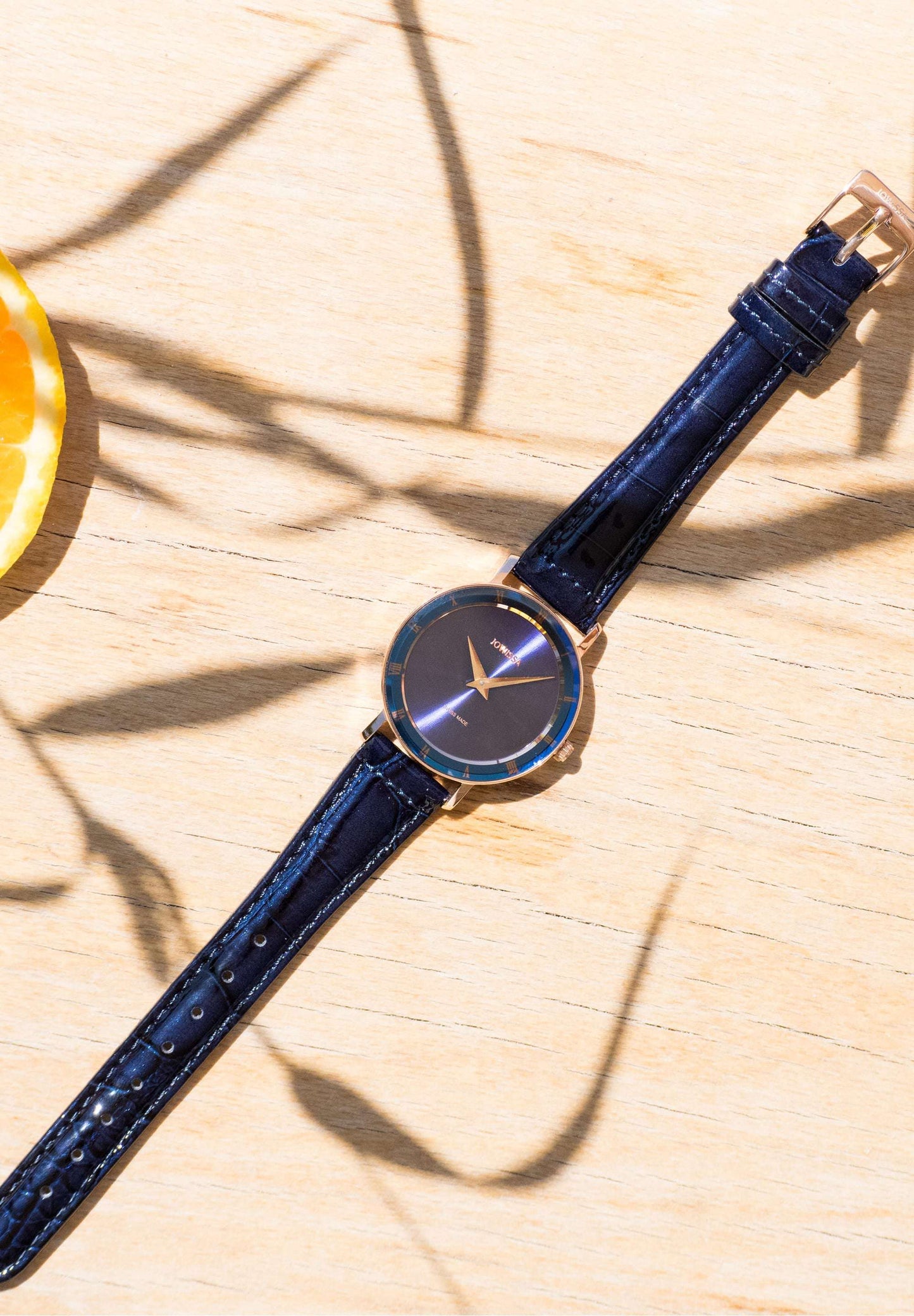 Blue swiss watch in table - The watch comes with an easily adjustable stainless steel bracelet. Its hand-assembled construction in Switzerland ensures premium quality and craftsmanship.