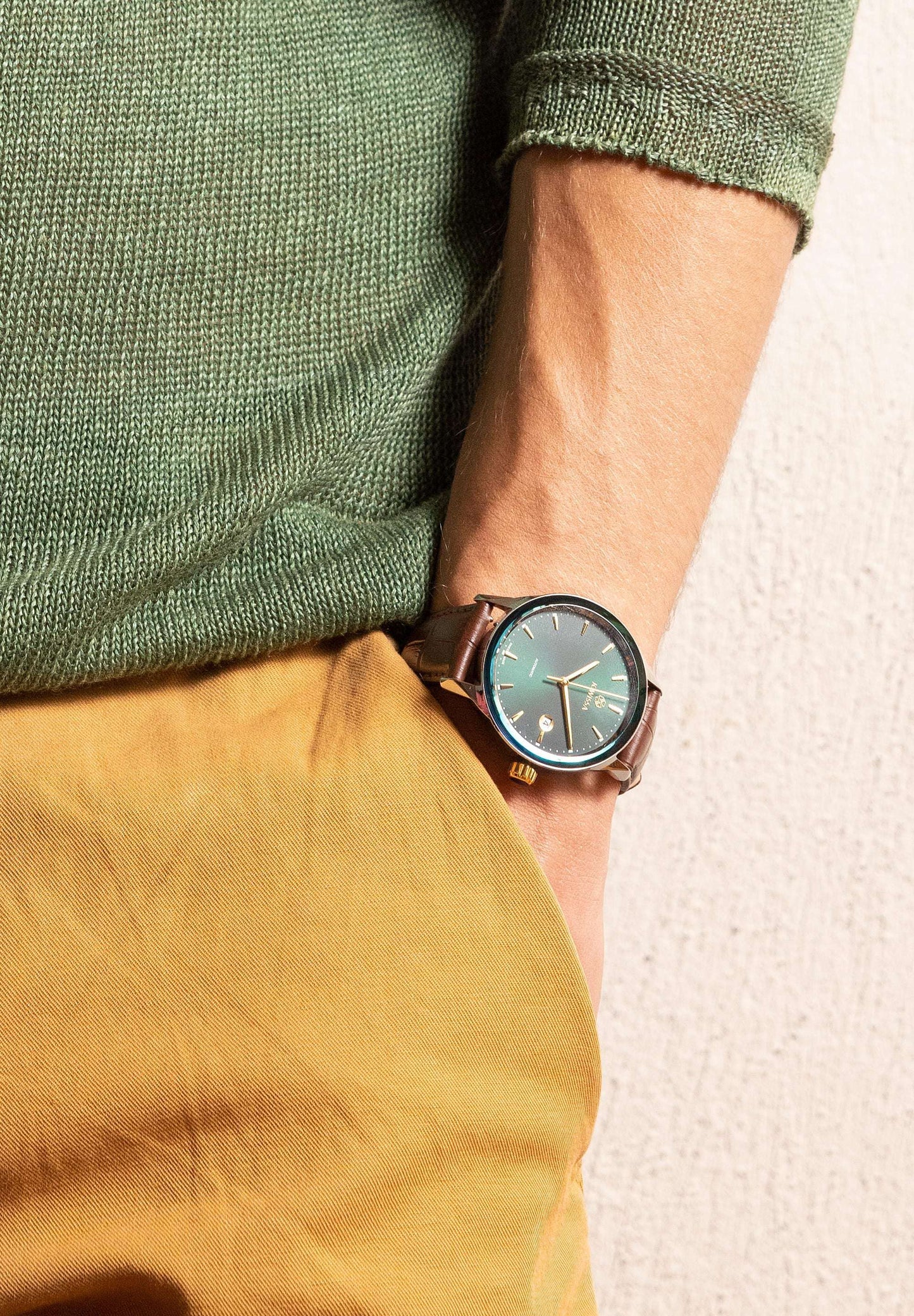 J4.557.L Virtuo Swiss watch for men - stainless steel - worn by a man with yellow pants and green shirt - with brown alligator-embossed leather strap - transparent back showcases the Swiss-made Ronda R150 automatic movement