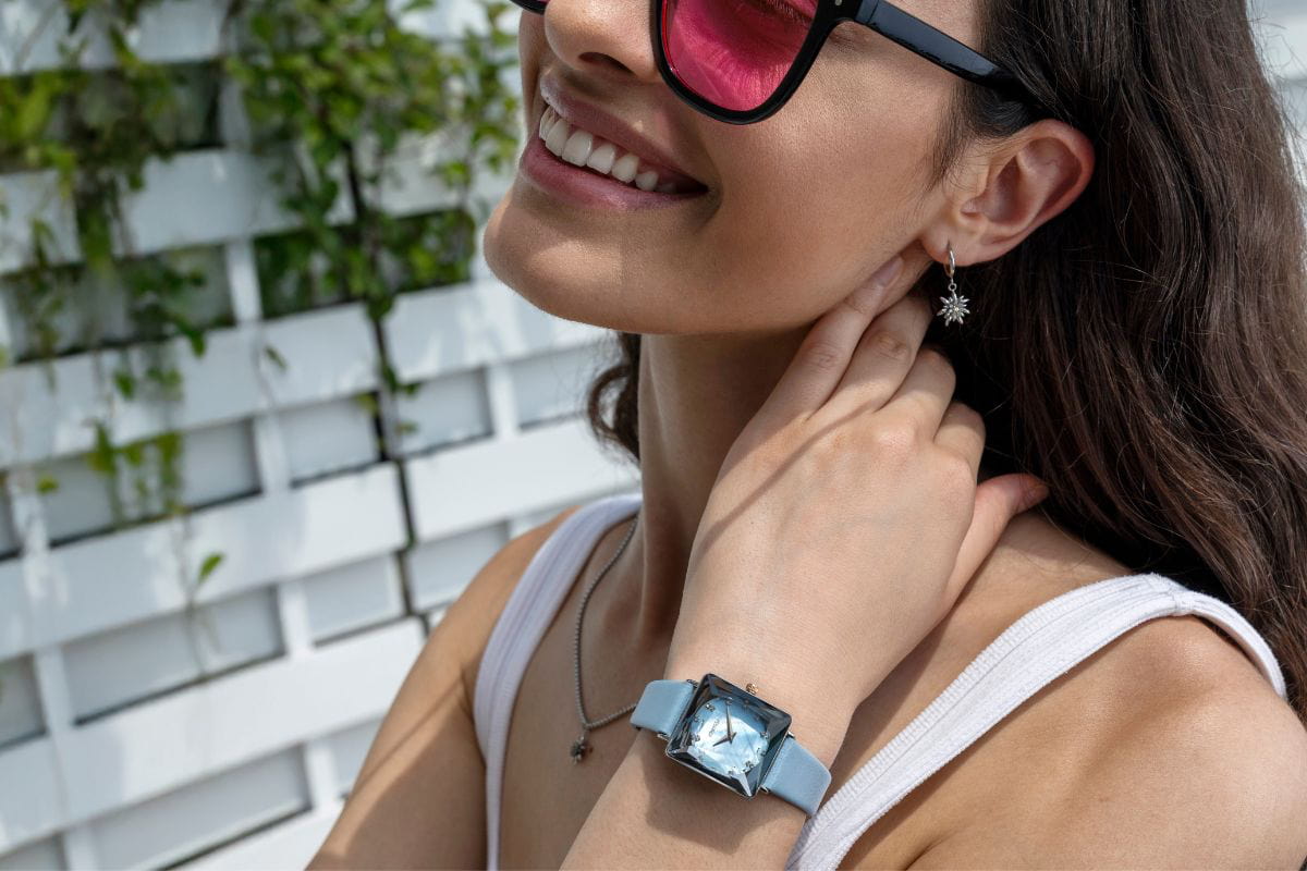 Baby blue ladies wrist watch with a baby blue mother of pearl dial and smooth leather strap. Square case and faceted glass.