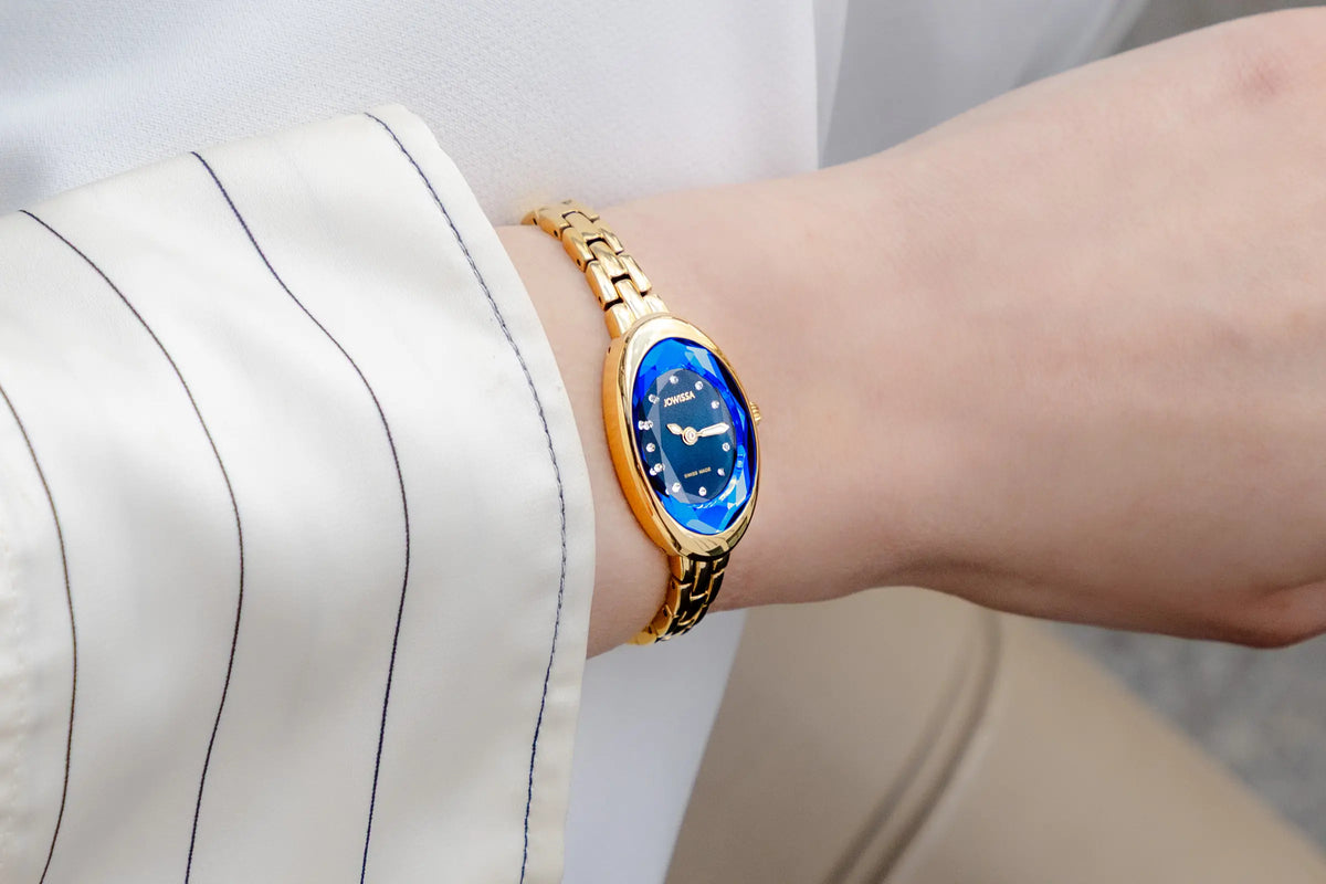 Jowissa Facet Oval Petite gold women's Swiss Made cocktail watch with a blue oval dial and bracelet