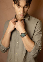 Swiss made watch for men - the watch has silver strap and green dial - has gold details in the front - all swiss made watch