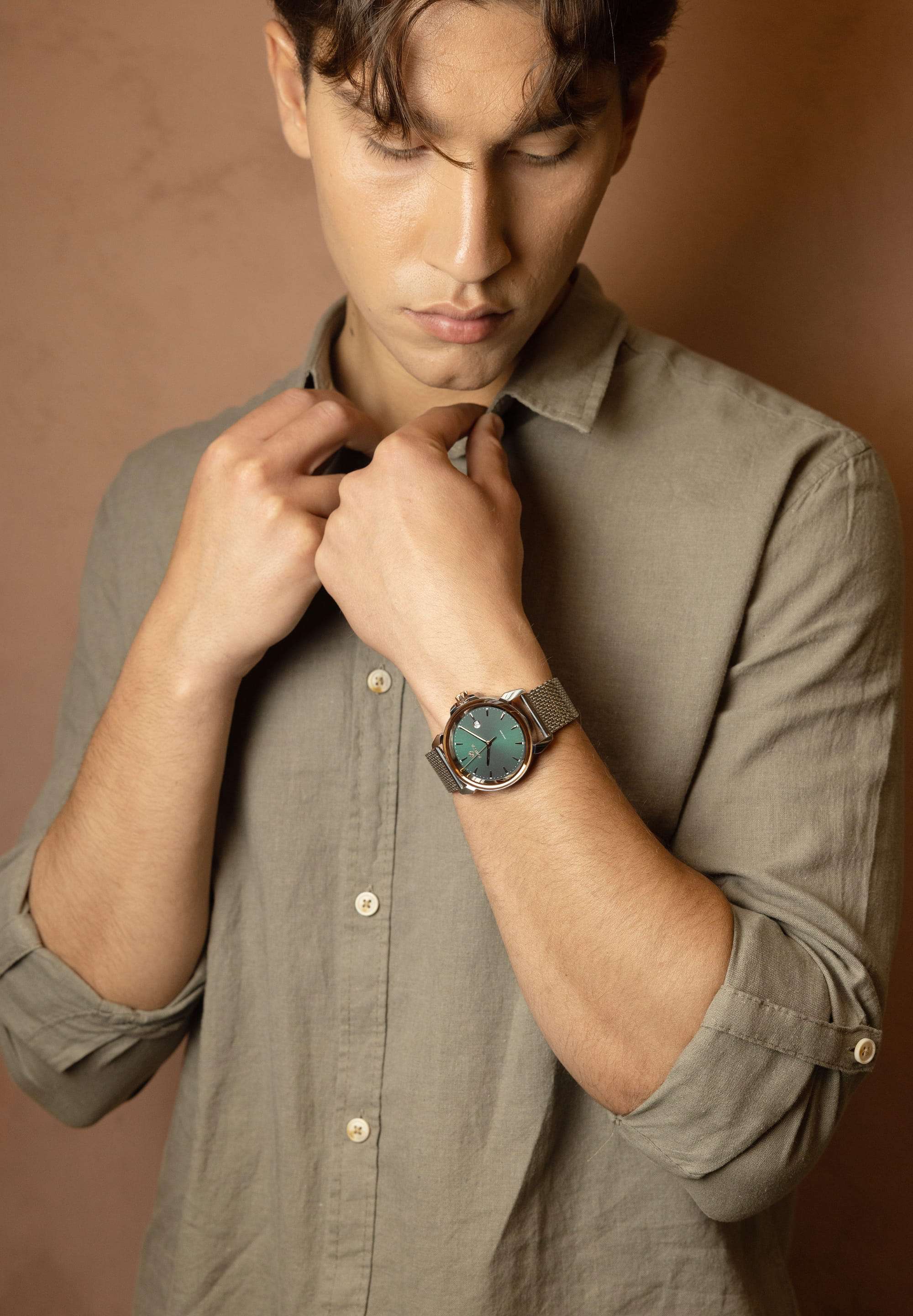 Swiss made watch for men - the watch has silver strap and green dial - has gold details in the front - all swiss made watch