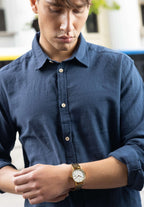 Swiss gold watch worn by a businessman - gold mens watch with white details on the front - all swiss made watch