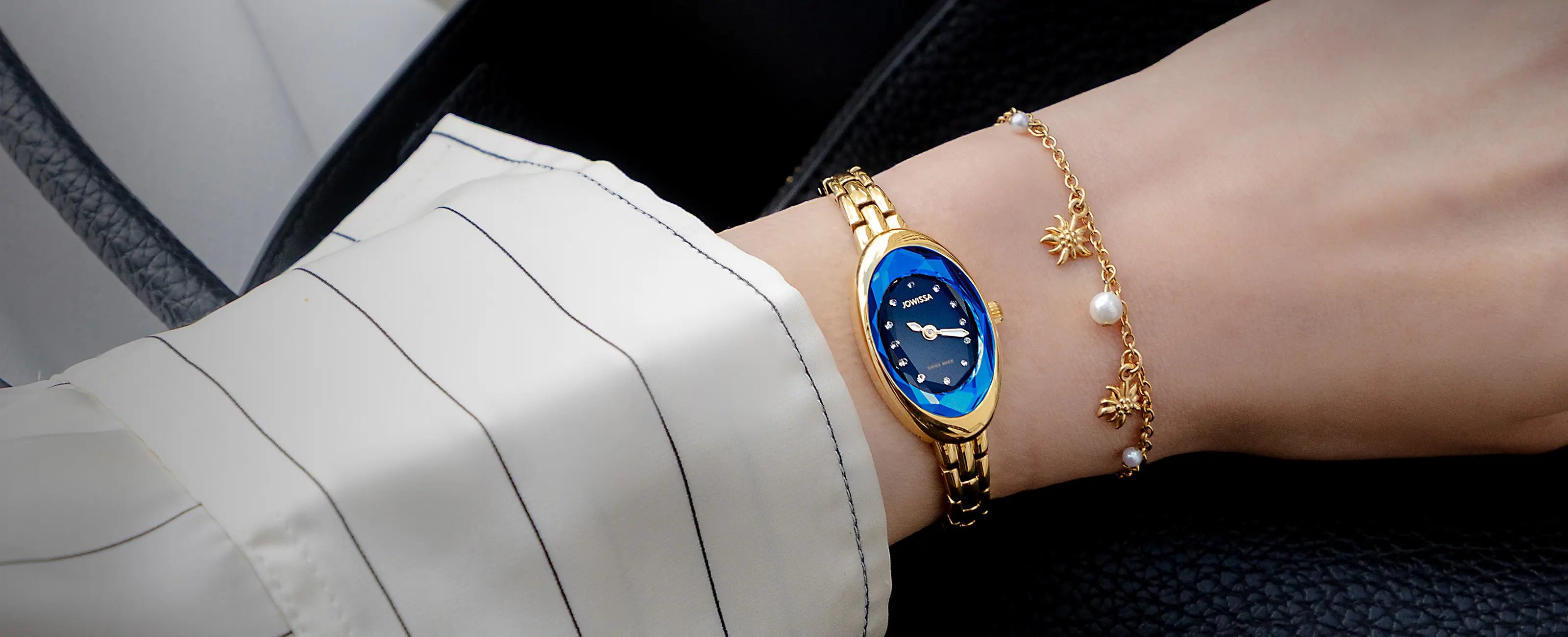Jowissa Facet Oval Petite - Small Swiss Made Luxury Cocktail Watch with oval case in gold color with blue dial and gold bracelet.