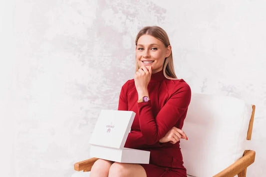 A women with red dress and jowissa swiss watch on her hand - the watch is swiss made with gold strap and purple dial