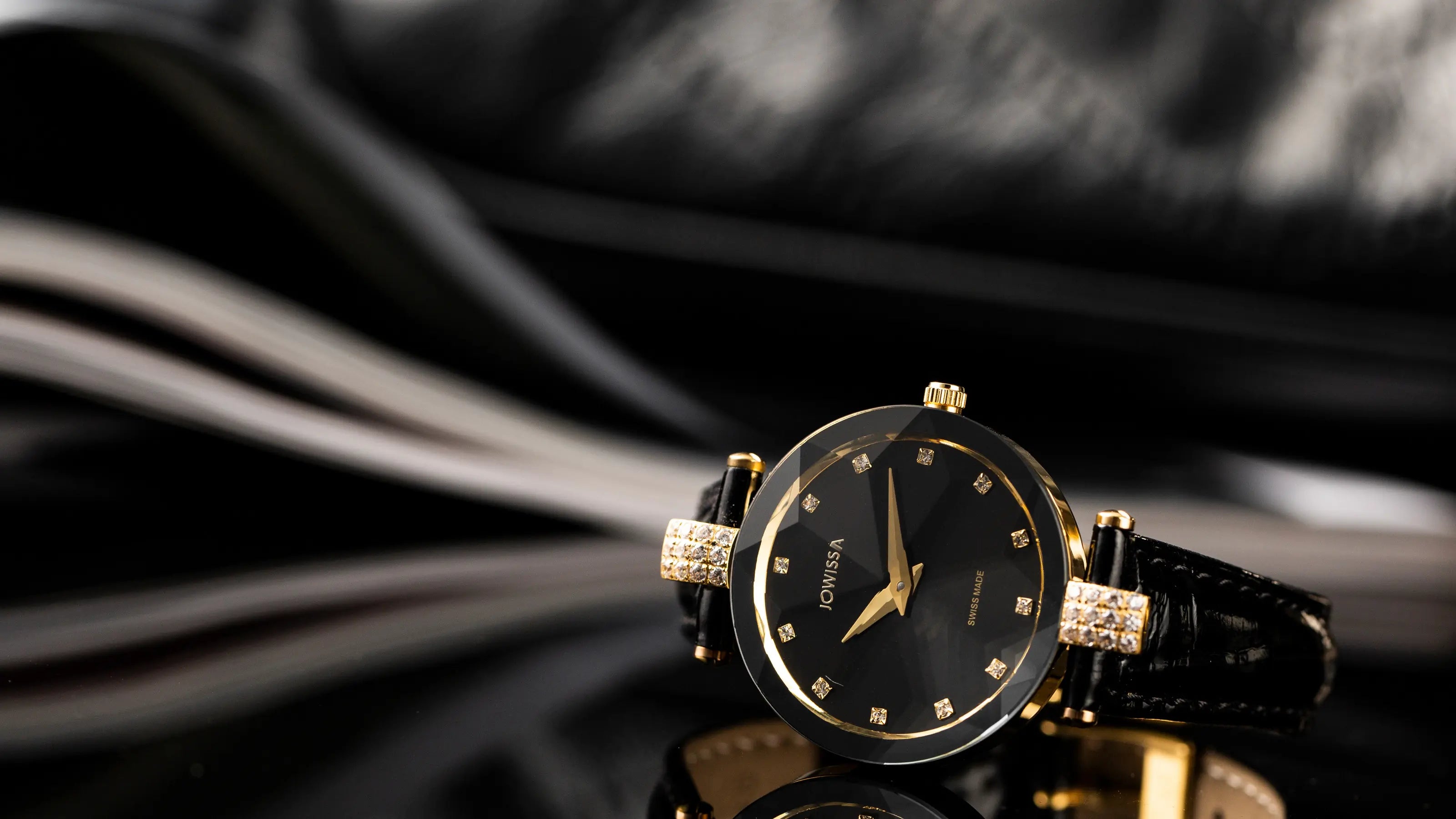 Iconic Jowissa Faceted Glass Watch: Facet Strass with black sunray dial, black leather band, and gold case—the ultimate Swiss Made dress watch for women.