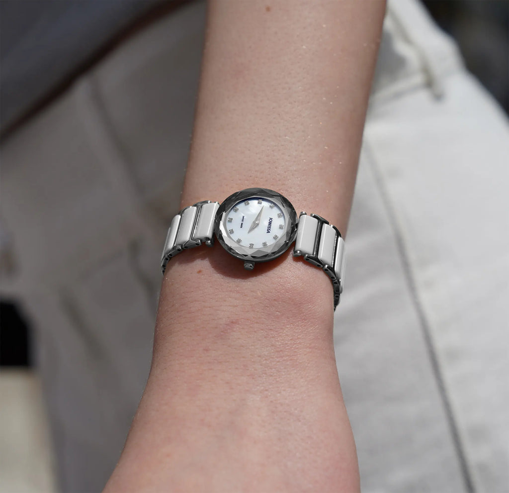 Small scratch resistant ladies watch with a white mother of pearl dial and a white ceramic bracelet. All Swiss Made.