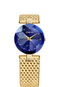 A Jowissa women's watch featuring a faceted crystal and a deep blue sunray dial with a gold-plated mesh bracelet with crystal accents.
