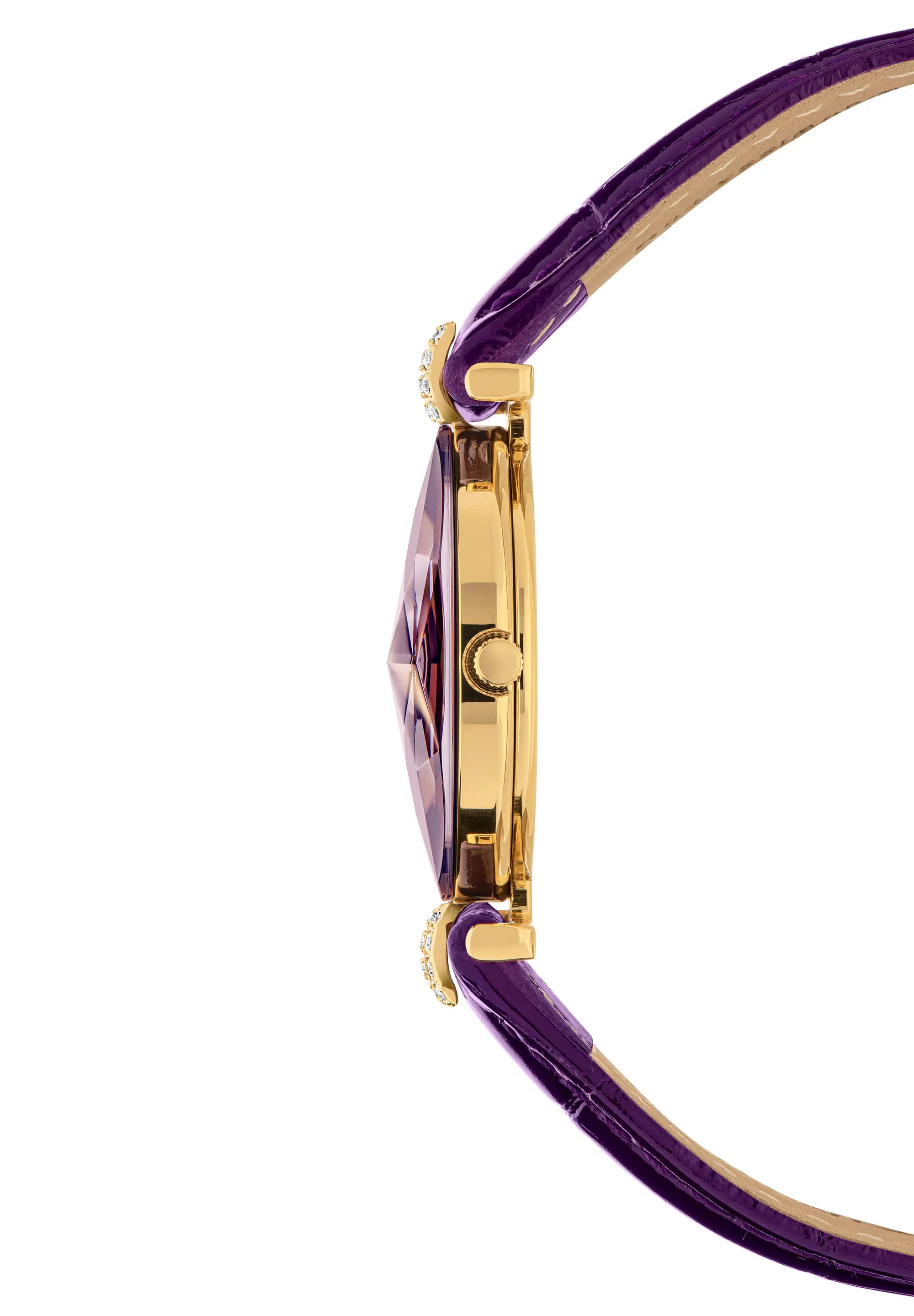 Close-up side view of a watch with a purple textured glossy leather strap, gold-tone case, and a faceted purple crystal with decor elements. Swiss Made.