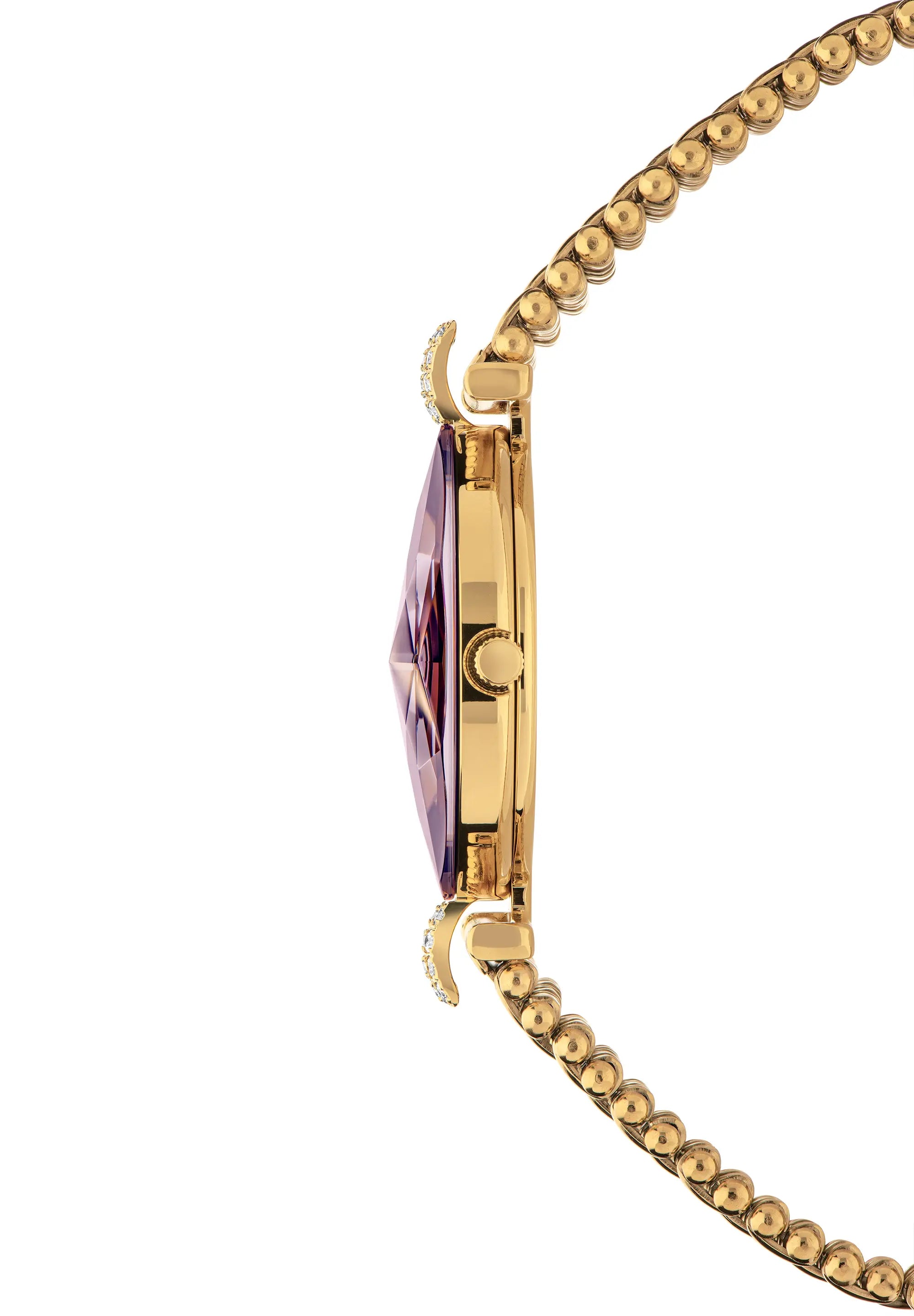 Close-up side view of a gold-tone watch with a faceted purple crystal and a gold beaded chain. Swiss Made Womens Watch by Jowissa.
