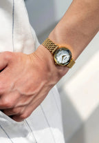 Nice little watch for everyday wear in gold. Crystal Radiance with a white mother of pearl dial and 12 rhinestones. Small stainless steel bracelet. All Swiss Made.