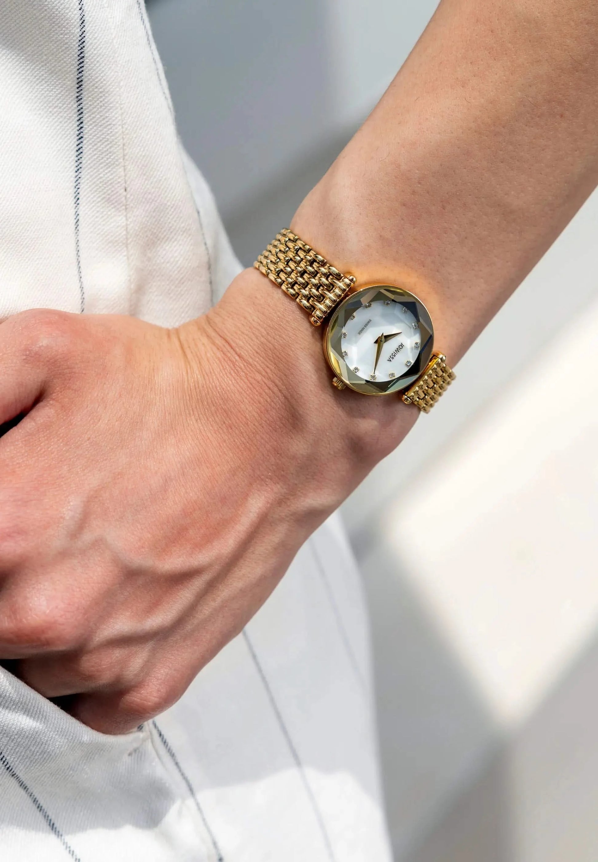 Nice little watch for everyday wear in gold. Crystal Radiance with a white mother of pearl dial and 12 rhinestones. Small stainless steel bracelet. All Swiss Made.