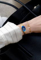 Perfect petite womens watch with an oval case shape and facetted crystal. Golden bracelet and blue dial. Jewelry like timepiece. Swiss Made.