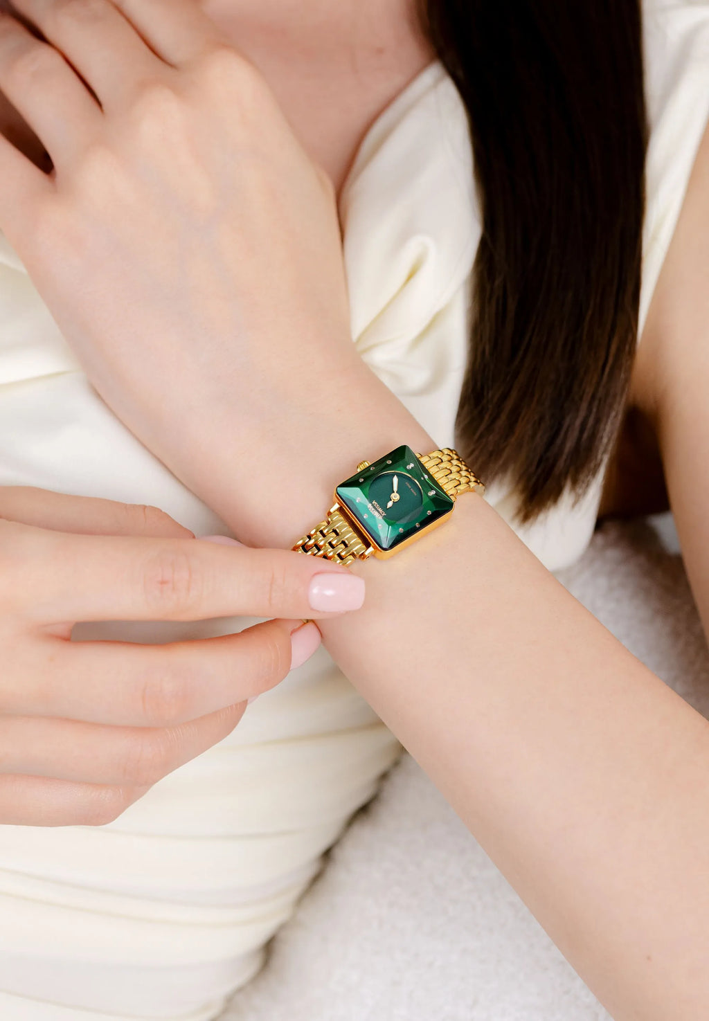 Gold ladies watch with a lush green dial. Small and elegant like jewelry. Swiss Made.