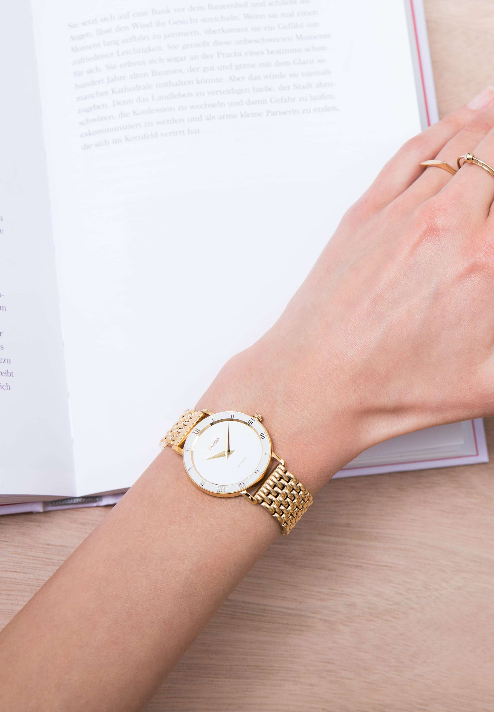 Roma watch for women - gold watch for ladies stainless steel made in switzerland for women - a girl is wearing the watch while reading a book - gold strap and white front