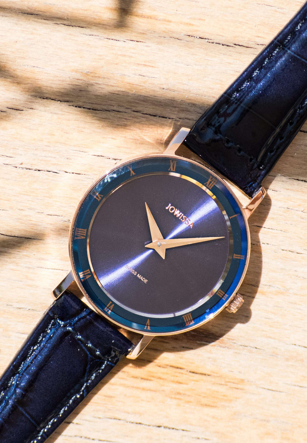 Blue swiss watch for women brings sophisticated style and classic colour to your wrist. It has an elegant blue dial, 30mm case and golden accents on the hour hands and Roman numerals. The darker blue bezel and shiny alligator-embossed leather strap add a luxurious finish. Made in Switzerland