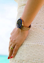 High quality black and gold watch J4.234.M - it is size medium - worn by a woman - has a stainless steel case - has a calendar - it is unisex - all swiss made