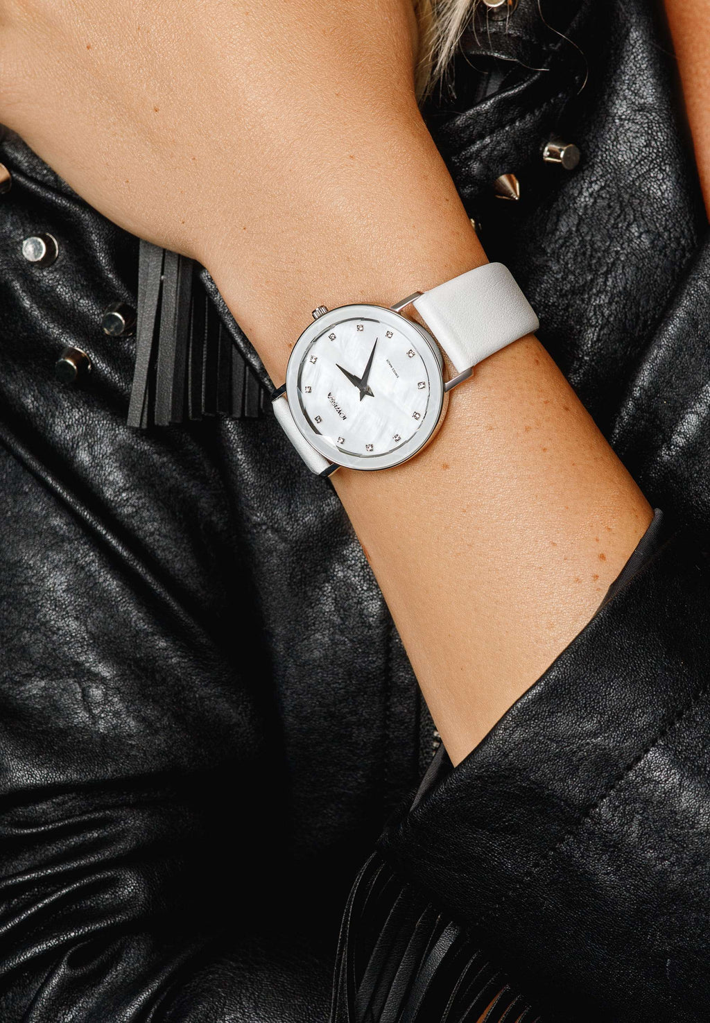 White leather watch for ladies - all swiss made with white strap and silver details - the watch is worn by a girl 