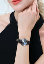 Swiss black watch for women - with black leather strap and black dial facet with gold details - worn by a woman with red lips