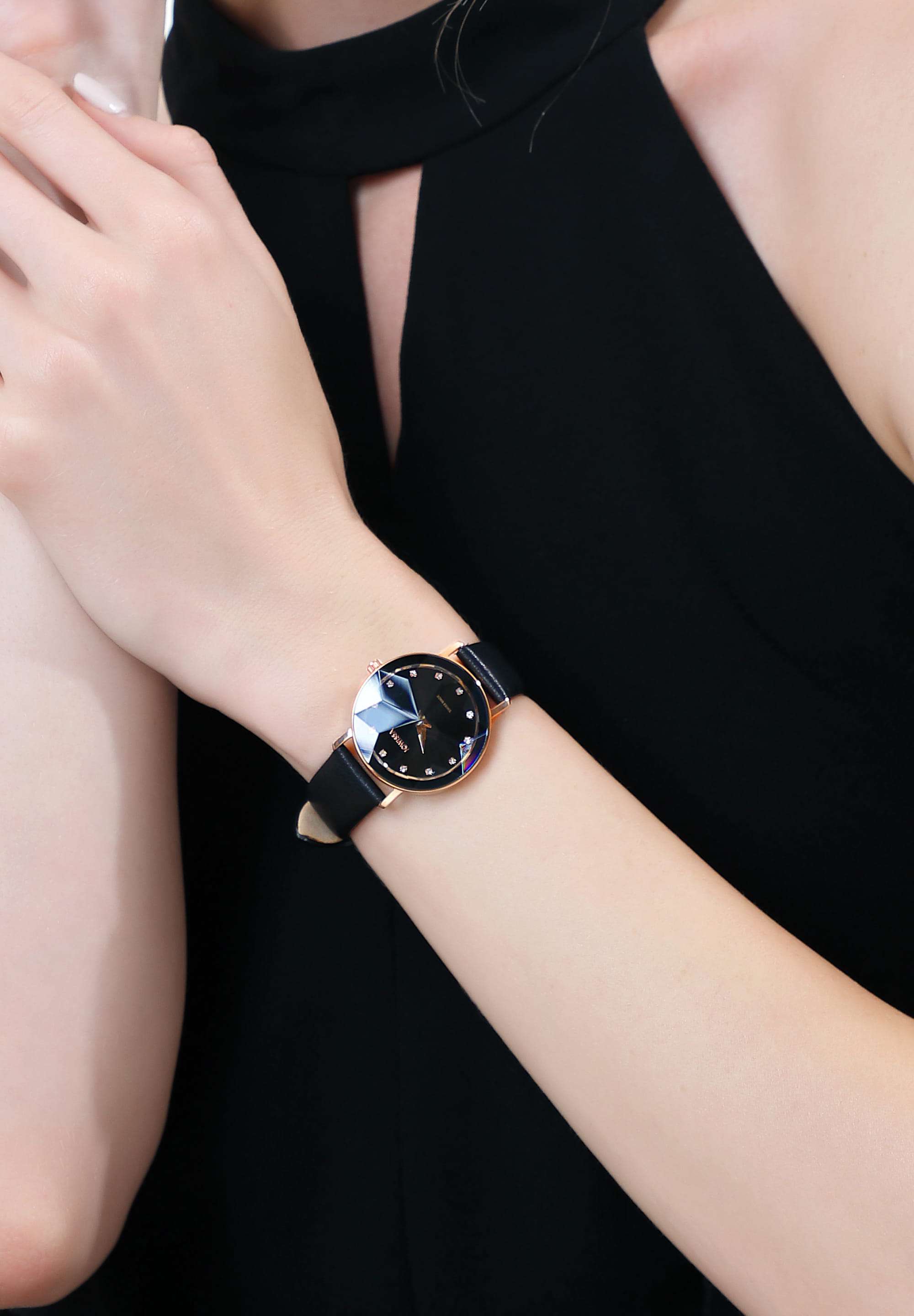 Black swiss watch for ladie with black leather strap and black dial with gold details in the front - all swiss made watch