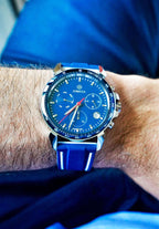 Swiss watch for men J7.108.L has blue leather strap and blue dial - all swiss made - a man with blue pants in wearing the watch