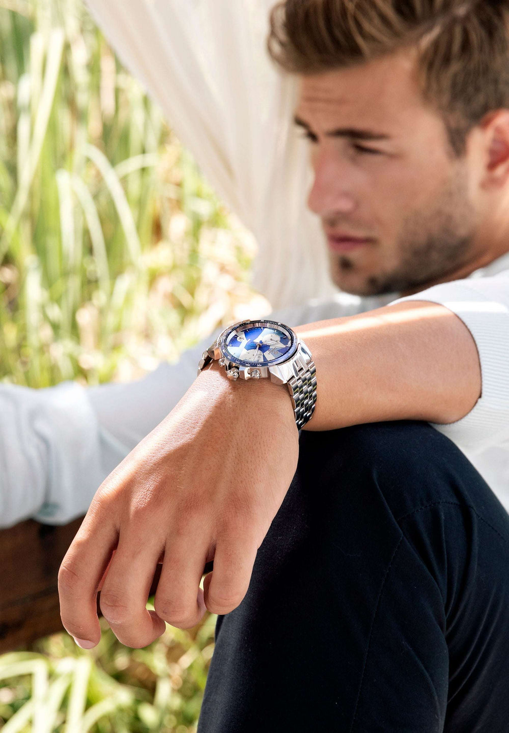 Silver watch made for men - has silver strap and blue dial - all swiss made for men