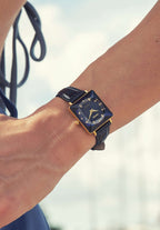 Swiss blue womens watch - with blue leather strap and blue dial - worn by a girl with blue pants