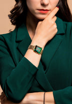 Swiss ladies watch - with gold strap and green dial - worn by a woman with green shirt - all swiss made watch for women
