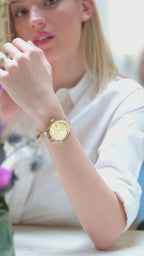 Swiss white watch for women - with gold and white strap and gold dial - worn by a girl with white shirt - all swiss made watch
