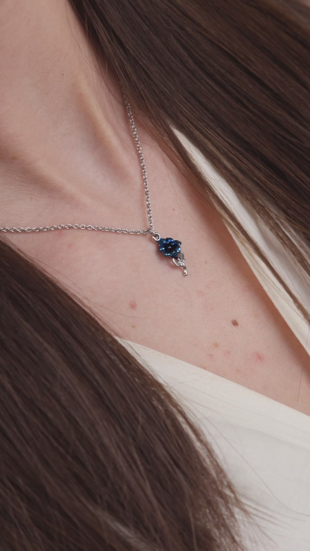 Swiss blue and silver necklace for women - worn by a girl with white shirt and brown hair