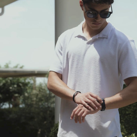 Swiss blue mens watch - all swiss made with blue leather strap and blue dial - worn by a man with white shirt