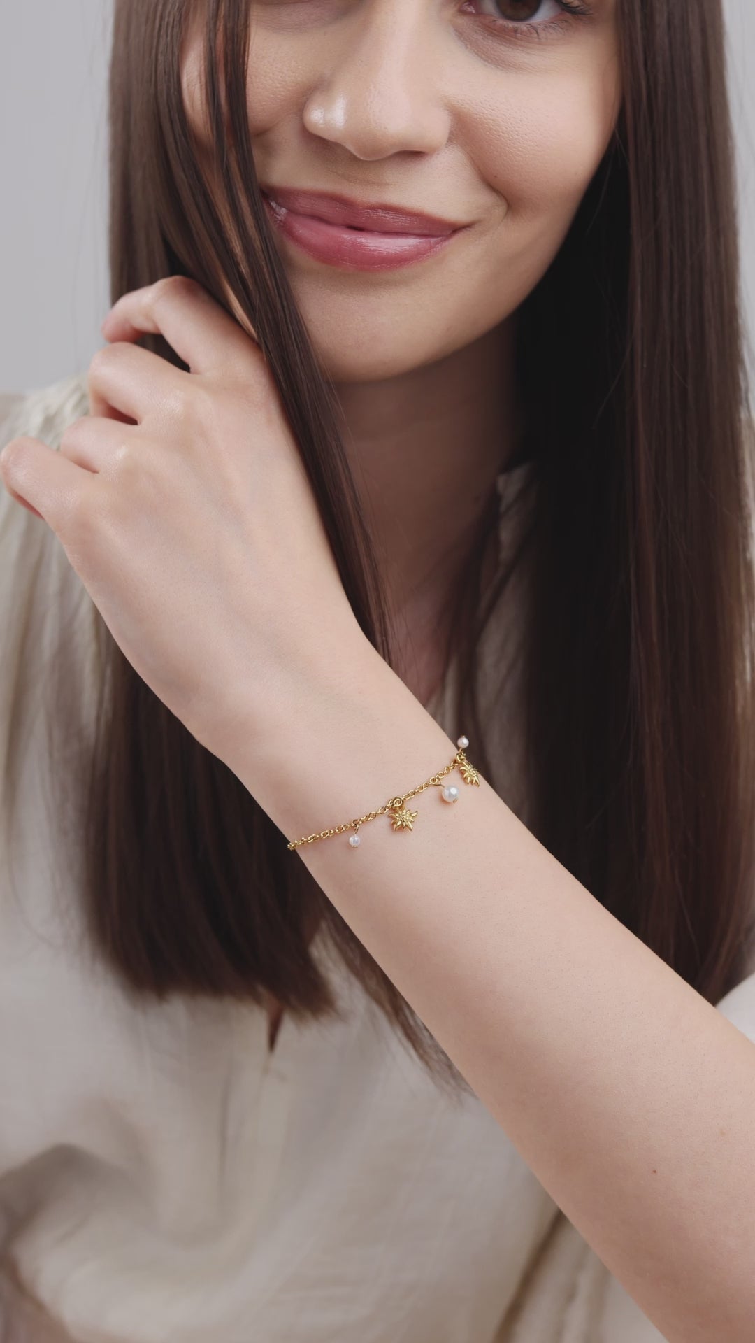 Swiss gold bracelet for women - with gold details worn by a girl with white shirt